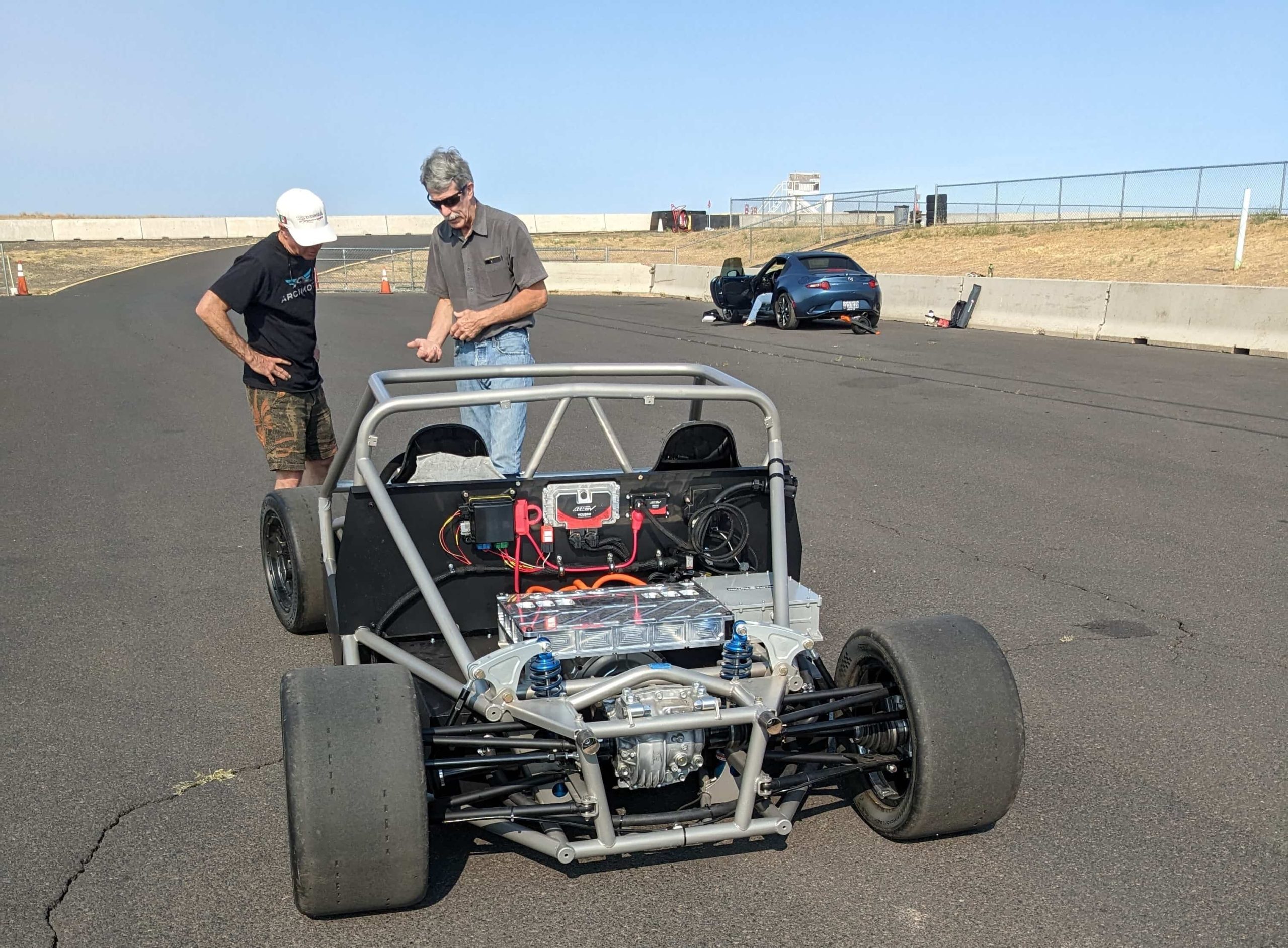 EVDrive engineers reviewing an electric vehicle powertrain installation